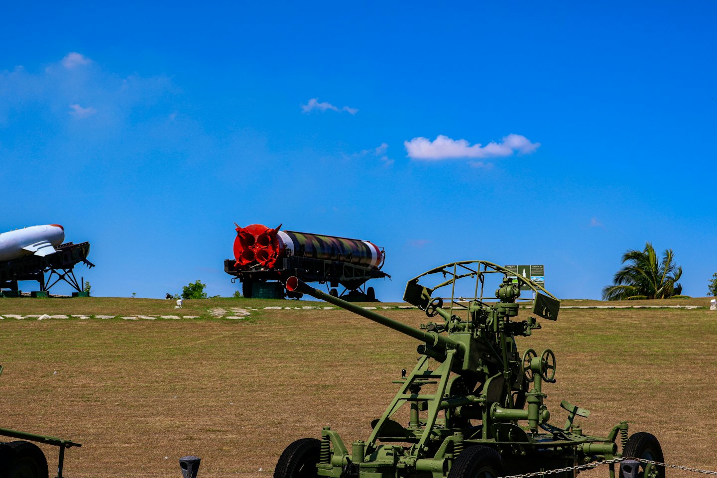 Military equipment displayed on a grassy field.